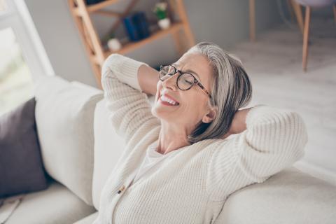 Image of senior woman relaxing on a couch