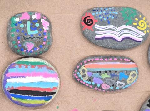 Picture of four painted rocks with different designs