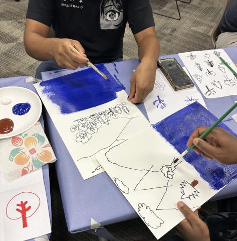 Adults painting trees