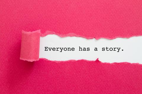 Pink paper torn to show the sentence: Everyone has a story.