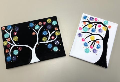 1 black and 1 white canvas with polka dot trees