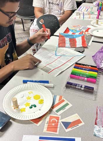 Adults working with art materials at a table