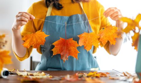 Woman holding a leaf garland