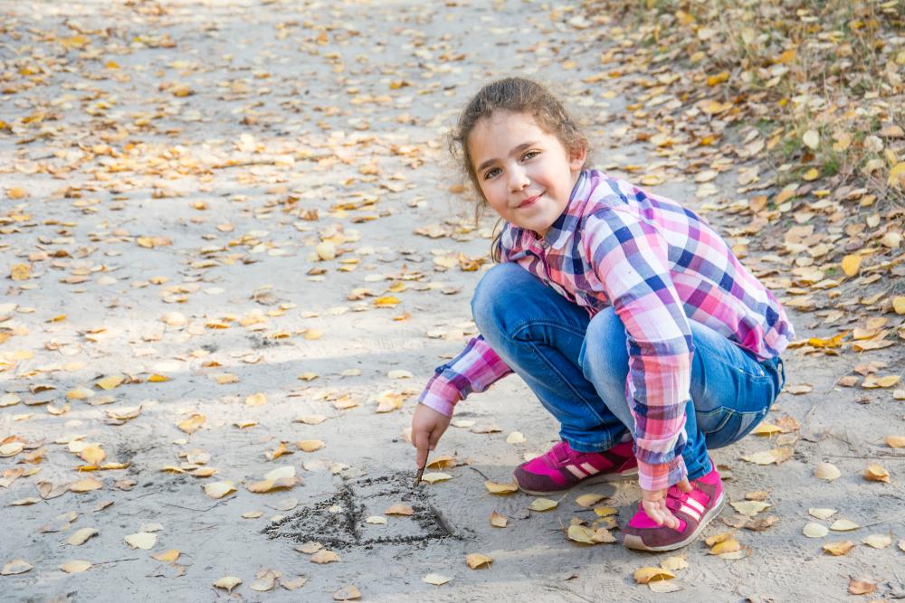 little girl drawing with chalk