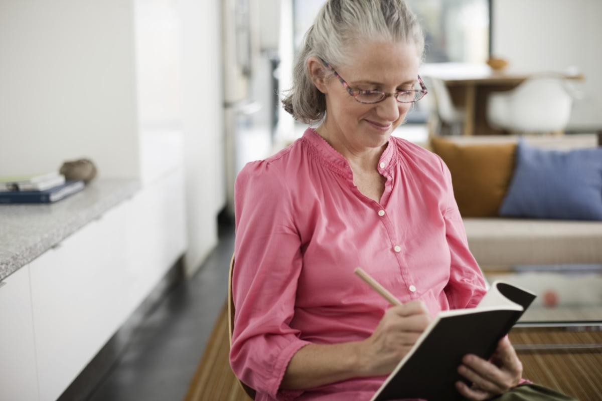 Woman writing in a book