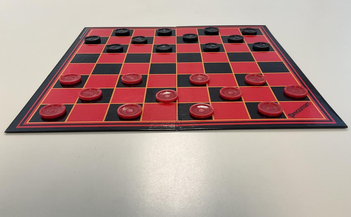 checker board with red and black pieces