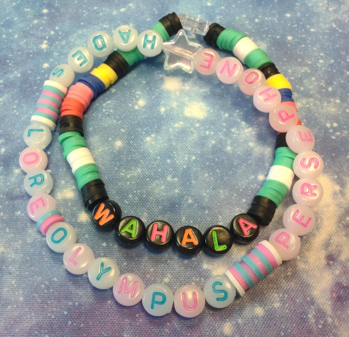 A pair of beaded bracelets lay on a mat.