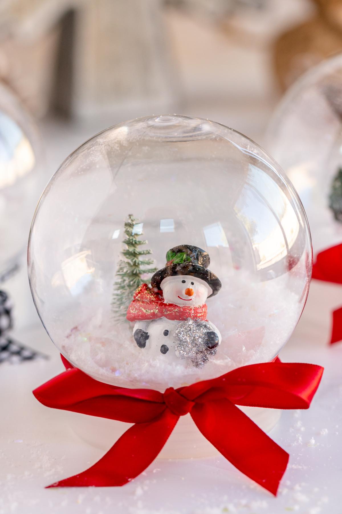 snowman snow globe with red ribbon