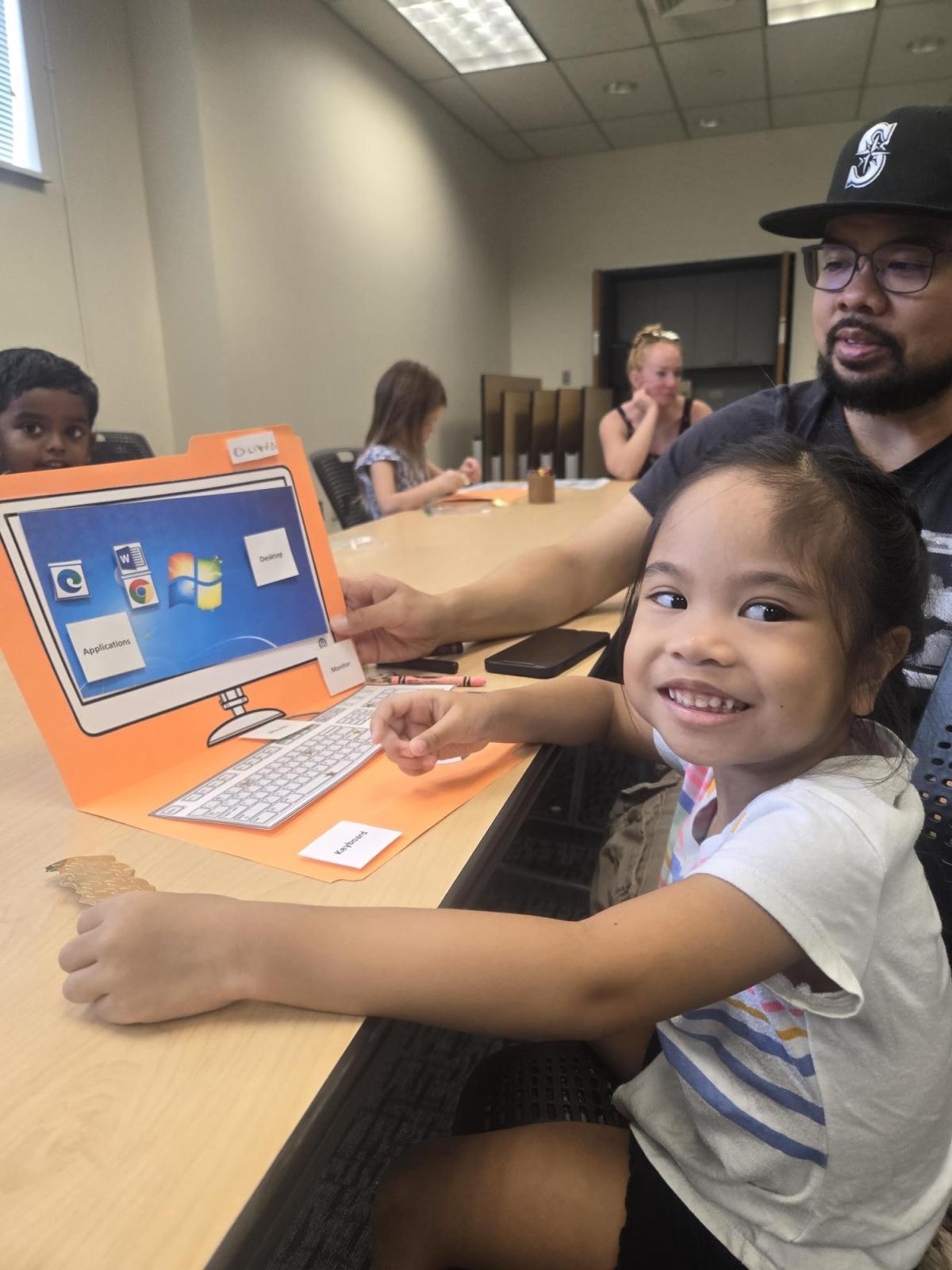 child with manila folder laptop computer