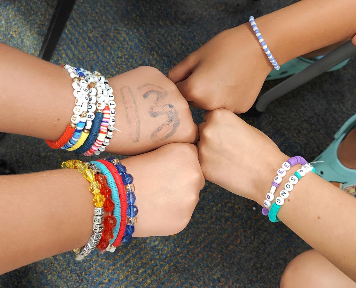 4 arms wearing friendship bracelets