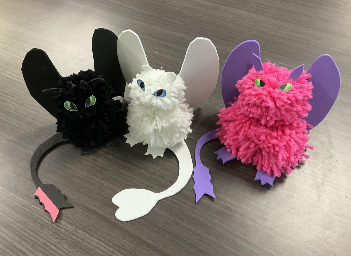 black, white, and magenta pom pom dragons