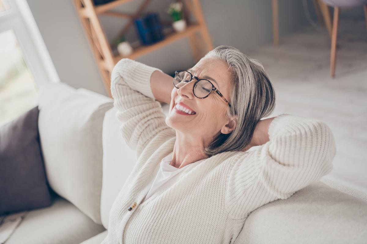 Image of senior woman relaxing on a couch