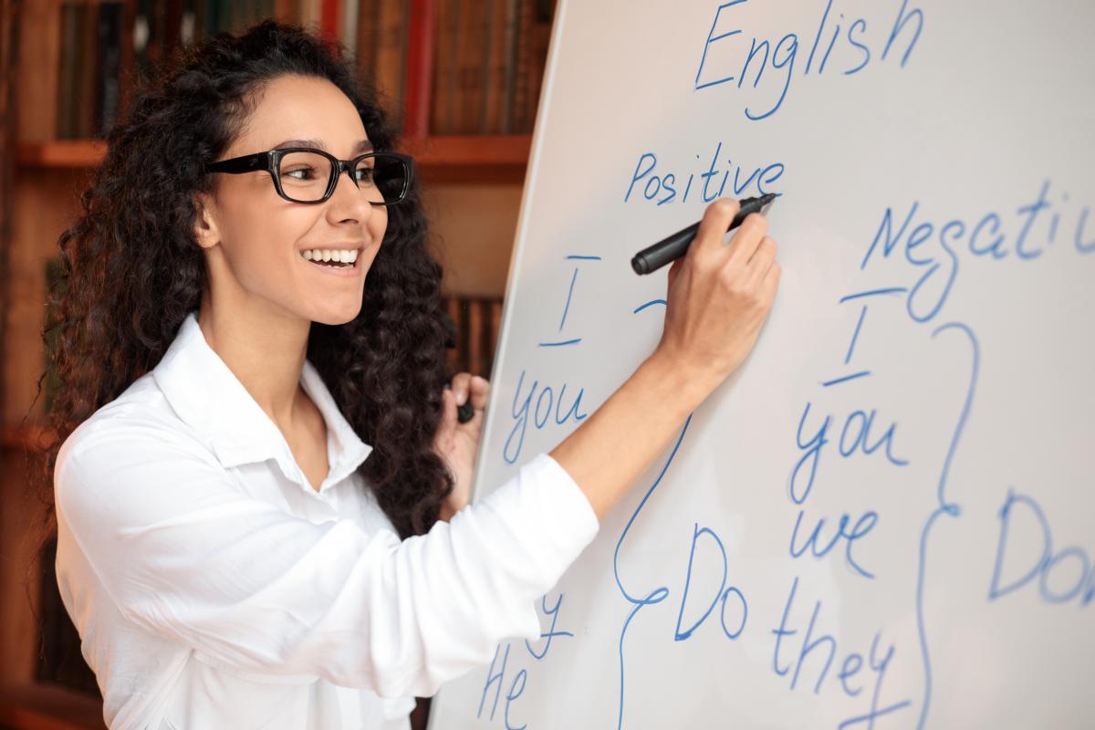 English language teacher writing on white board