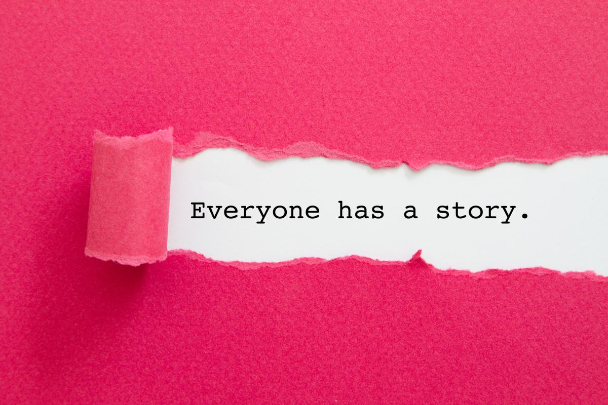 Pink paper torn to show the sentence: Everyone has a story.