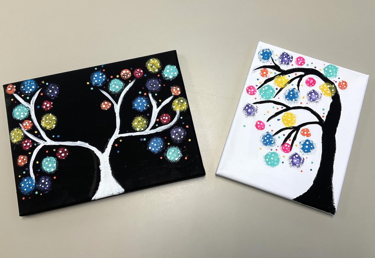 1 black and 1 white canvas with polka dot trees