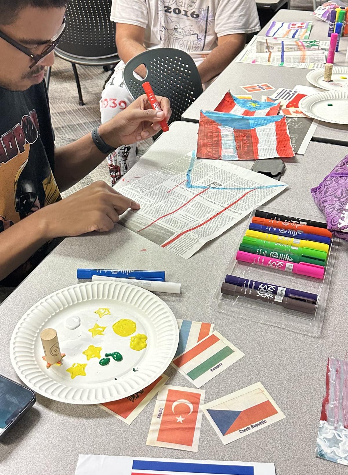 Adults working with art materials at a table